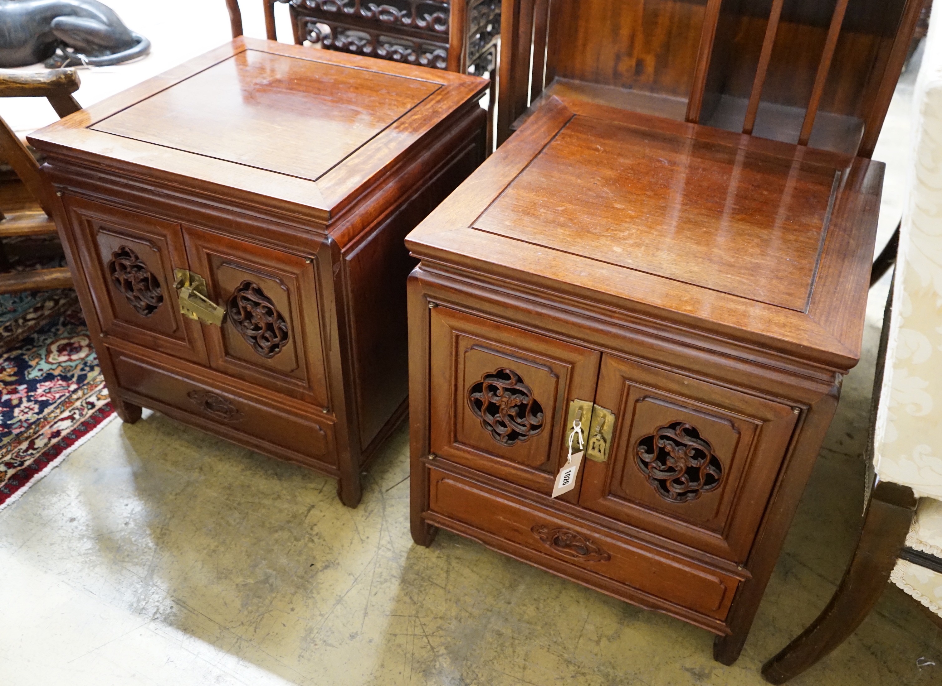 A pair of Chinese carved padouk bedside cabinets, width 51cm, depth 51cm, height 56cm